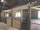 Spacious barn interior with multiple horse stalls, providing comfort and functionality at 9909 E Mcgregor Rd, Indianapolis, IN 46259