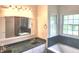 Bathroom featuring glass shower and tub with green marble at 9909 E Mcgregor Rd, Indianapolis, IN 46259