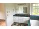 Bathroom with a dual sink vanity and a large mirror at 9909 E Mcgregor Rd, Indianapolis, IN 46259