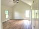 Bright bedroom with high ceilings, large windows, and hardwood floors, offering ample natural light and space at 9909 E Mcgregor Rd, Indianapolis, IN 46259