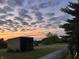 Exterior of a metal building with fencing and green pastures at sunset at 9909 E Mcgregor Rd, Indianapolis, IN 46259