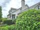 Beautiful home exterior with a covered porch, manicured landscaping, and lush greenery at 9909 E Mcgregor Rd, Indianapolis, IN 46259