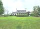 Traditional home with a well-manicured front lawn and mature landscaping in a quiet neighborhood at 9909 E Mcgregor Rd, Indianapolis, IN 46259