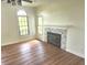 Living room with hardwood floors and a fireplace at 9909 E Mcgregor Rd, Indianapolis, IN 46259
