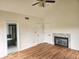 Main bedroom featuring a ceiling fan, hardwood floors, fireplace, and ensuite bathroom offering comfort and style at 9909 E Mcgregor Rd, Indianapolis, IN 46259