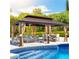 Outdoor gazebo lounge area next to a sparkling pool for relaxation and entertainment at 9909 E Mcgregor Rd, Indianapolis, IN 46259