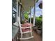 Inviting front porch with rocking chairs and columns at 9909 E Mcgregor Rd, Indianapolis, IN 46259