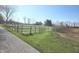 Scenic view of the property featuring a fenced pasture and a glimpse of the house at 9909 E Mcgregor Rd, Indianapolis, IN 46259