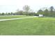 Sprawling green yard with white fencing and a gravel driveway, perfect for outdoor activities at 9909 E Mcgregor Rd, Indianapolis, IN 46259