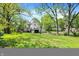Spacious backyard featuring a well-manicured lawn and mature trees offering privacy and shade at 1000 E King St, Franklin, IN 46131