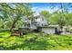Large backyard with mature trees, a firepit, and a detached garage providing plenty of outdoor space at 1000 E King St, Franklin, IN 46131