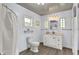 Bright bathroom features a white vanity with storage, a toilet, and a shower with a curtain for privacy at 1000 E King St, Franklin, IN 46131