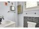 This bathroom offers a modern sink, toilet, mirror, and stylish mosaic tile accents at 1000 E King St, Franklin, IN 46131
