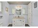 Bright bathroom features a white vanity with storage, flanked by large glass block windows, with a large mirror at 1000 E King St, Franklin, IN 46131
