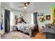 Cozy bedroom with a ceiling fan, comfortable bed, and vibrant wall decor at 1000 E King St, Franklin, IN 46131