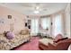Cozy pink bedroom featuring soft lighting, a ceiling fan, and ample natural light at 1000 E King St, Franklin, IN 46131