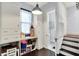 Entryway area with white storage cabinets, work desk, and a staircase to the side at 1000 E King St, Franklin, IN 46131