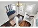 Beautiful foyer with a view of the living room, showcasing hardwood floors and staircase with white railings at 1000 E King St, Franklin, IN 46131