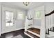 Elegant foyer with hardwood floors, staircase, and stained glass windows, creating a welcoming entrance at 1000 E King St, Franklin, IN 46131