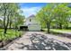 Detached garage with a spacious driveway, offering ample parking and storage space in the backyard at 1000 E King St, Franklin, IN 46131