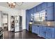 Kitchen features blue cabinets, stainless steel appliances, and hardwood floors at 1000 E King St, Franklin, IN 46131