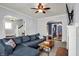 Cozy living room with a comfortable sectional sofa, arched doorways, and a fireplace, ideal for entertaining at 1000 E King St, Franklin, IN 46131