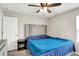 Bedroom with a blue comforter, a ceiling fan and light, a nightstand, and carpeted floor at 10236 Arctic Edge Dr, Indianapolis, IN 46239