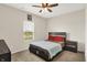Cozy bedroom with ceiling fan, neutral walls, and carpet flooring, illuminated by natural light at 10236 Arctic Edge Dr, Indianapolis, IN 46239