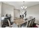 Spacious dining room featuring a large table, dark wood floors, modern chandelier, and a bar area with beverages at 10236 Arctic Edge Dr, Indianapolis, IN 46239