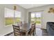 Bright dining room with view of pond and wood table set for six at 10236 Arctic Edge Dr, Indianapolis, IN 46239