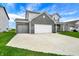 Spacious two-story home with black brick, gray siding, concrete driveway, attached two-car garage, and well-kept front lawn at 10236 Arctic Edge Dr, Indianapolis, IN 46239