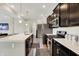 Contemporary kitchen featuring stainless steel appliances, dark wood cabinets, and subway tile backsplash at 10236 Arctic Edge Dr, Indianapolis, IN 46239