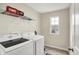 Well-lit laundry room with modern washer and dryer set at 10236 Arctic Edge Dr, Indianapolis, IN 46239