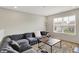 Bright living room with a large gray sectional sofa and a wooden coffee table at 10236 Arctic Edge Dr, Indianapolis, IN 46239