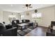 Bright living room with a ceiling fan and several windows providing scenic neighborhood views at 10236 Arctic Edge Dr, Indianapolis, IN 46239