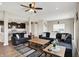 Inviting living room with neutral walls, ceiling fan, wood floors, and comfortable seating at 10236 Arctic Edge Dr, Indianapolis, IN 46239