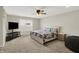 Spacious main bedroom with a ceiling fan, large bed and TV at 10236 Arctic Edge Dr, Indianapolis, IN 46239