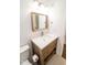 Stylish bathroom with a wooden vanity, white countertop, decorative mirror, and tile flooring at 1046 Timber Creek Dr # 3, Carmel, IN 46032