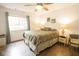 Bright bedroom featuring a ceiling fan, neutral walls, and a window with peaceful outdoor views at 1046 Timber Creek Dr # 3, Carmel, IN 46032
