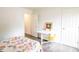 Bright bedroom with desk area, closet, and colorful bedding and plank flooring at 1046 Timber Creek Dr # 3, Carmel, IN 46032