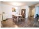 Open concept dining area with modern table, chairs, and sleek display cabinet at 1046 Timber Creek Dr # 3, Carmel, IN 46032