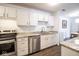 Modern kitchen with stainless steel appliances, sleek white cabinetry, and granite countertops at 1046 Timber Creek Dr # 3, Carmel, IN 46032