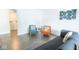 Cozy living room featuring modern furniture, gray plank flooring, and easy access to a laundry area at 1046 Timber Creek Dr # 3, Carmel, IN 46032