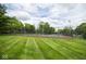 Well-maintained tennis court surrounded by lush greenery at 1046 Timber Creek Dr # 3, Carmel, IN 46032