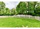 Expansive backyard with lush green lawn and privacy fence, providing a serene and secure outdoor space at 10713 Stable Dr, Indianapolis, IN 46239