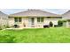A well-maintained backyard features a patio, manicured lawn, and mature landscaping, perfect for relaxing or entertaining at 10713 Stable Dr, Indianapolis, IN 46239