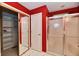 Bathroom: tiled floor, shower with glass door, access to closet, and red walls at 10713 Stable Dr, Indianapolis, IN 46239