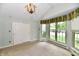 Airy bedroom with vaulted ceiling, a closet with mirrored doors, and an abundance of natural light through large windows at 10713 Stable Dr, Indianapolis, IN 46239
