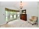 Bright bedroom with a vaulted ceiling, elegant chandelier, and bay window with greenery views at 10713 Stable Dr, Indianapolis, IN 46239
