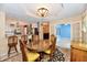 Open concept: dining room view with kitchen, access to Florida room and blue walls at 10713 Stable Dr, Indianapolis, IN 46239